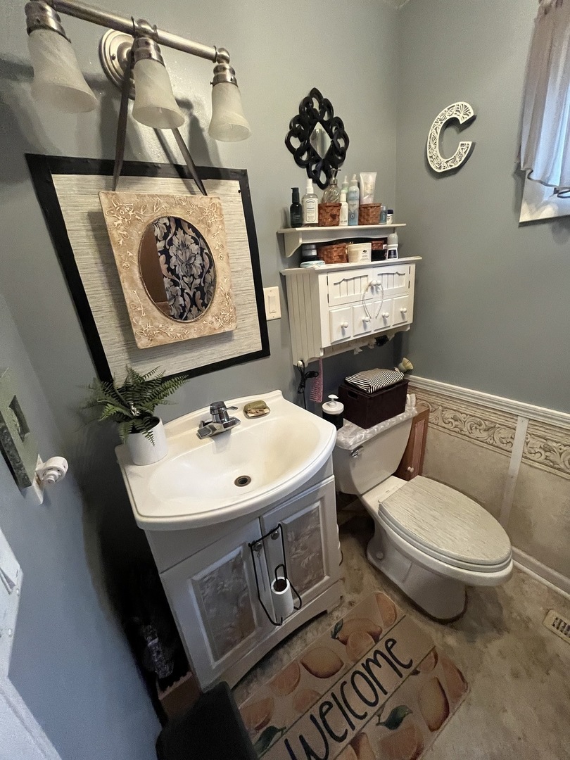 15213 Waverly Avenue Midlothian, IL 60445 - Photo 8 of 12 a bathroom with a sink toilet and mirror