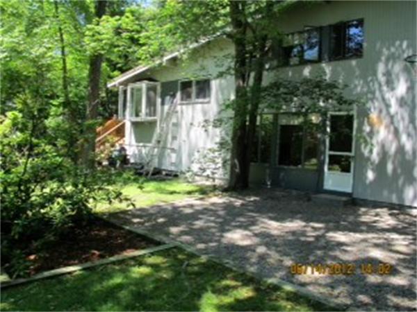 29 Peacock Farm Road Lexington, MA 02421 - Photo 2 of 12 a view of a yard in front of a house with large windows