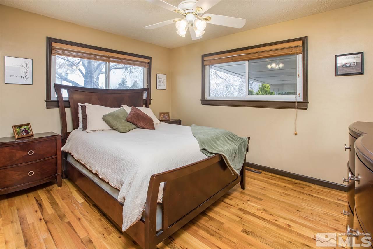 2890 Judith Lane Reno, NV 89503 - Photo 12 of 25 a bedroom with a bed and a chandelier