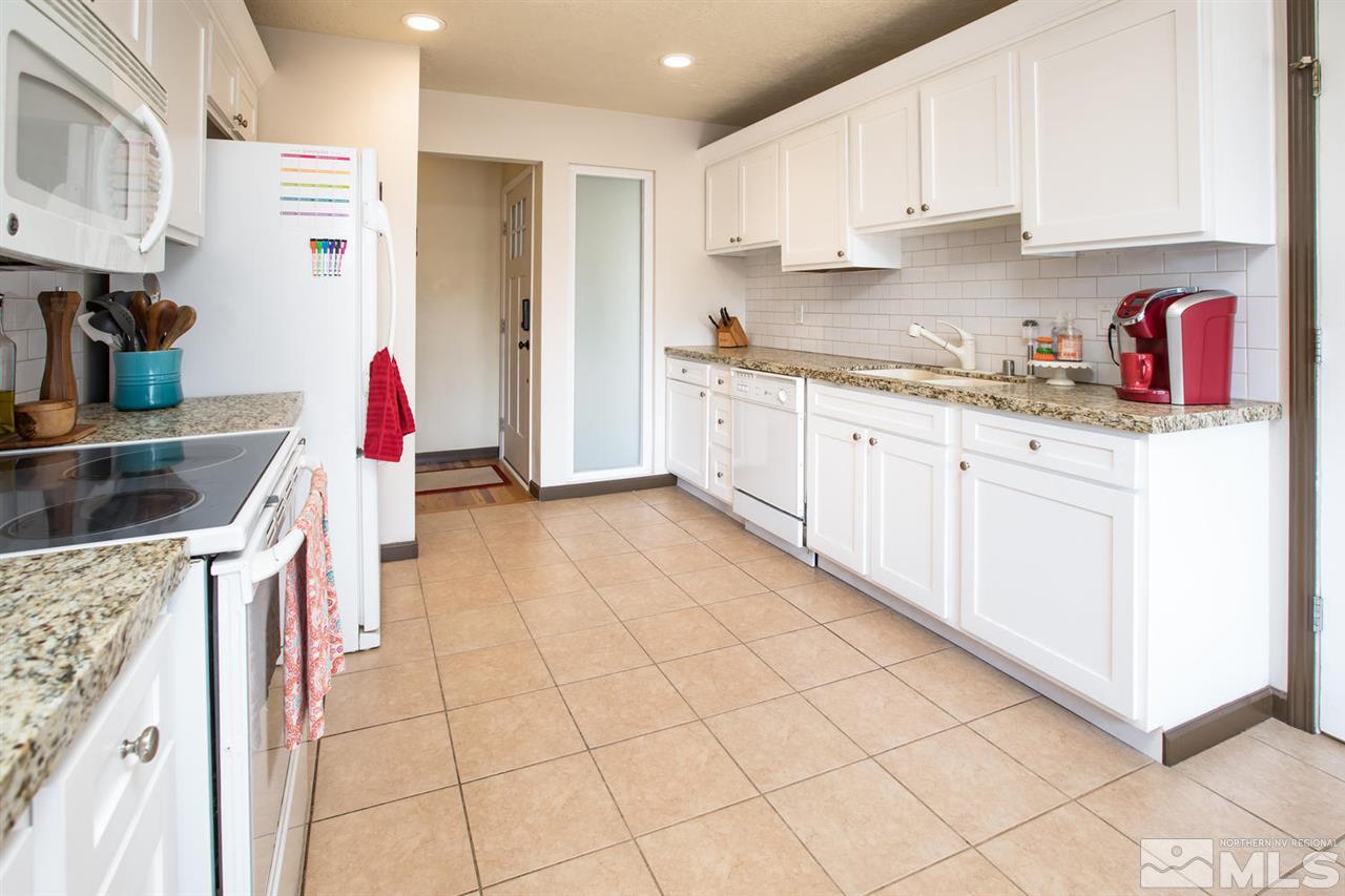 2890 Judith Lane Reno, NV 89503 - Photo 7 of 25 a kitchen with stainless steel appliances granite countertop a sink and cabinets