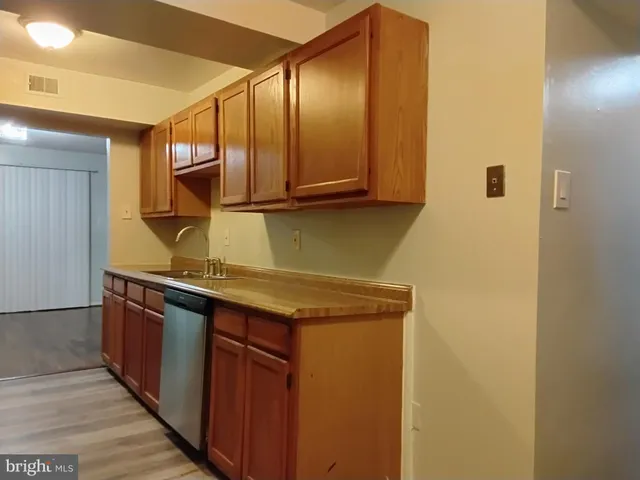 a kitchen with stainless steel appliances granite countertop a sink and cabinets