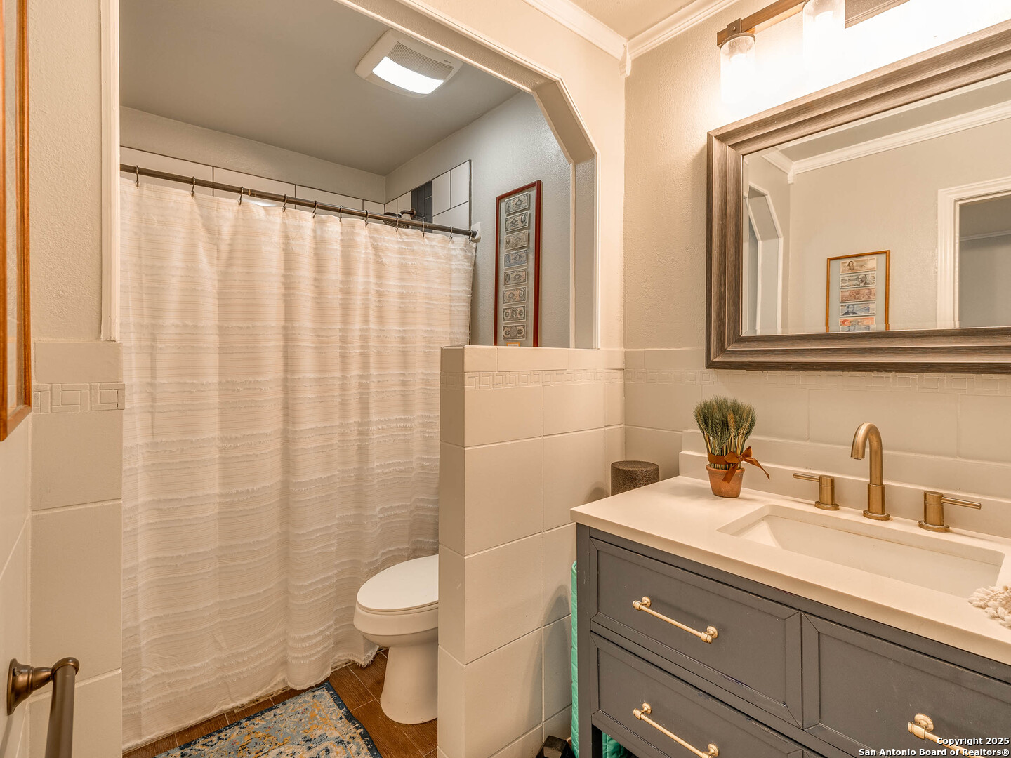 7711 Callaghan Road, Unit 702 San Antonio, TX 78229 - Photo 12 of 49 a bathroom with a granite countertop sink a toilet and a mirror