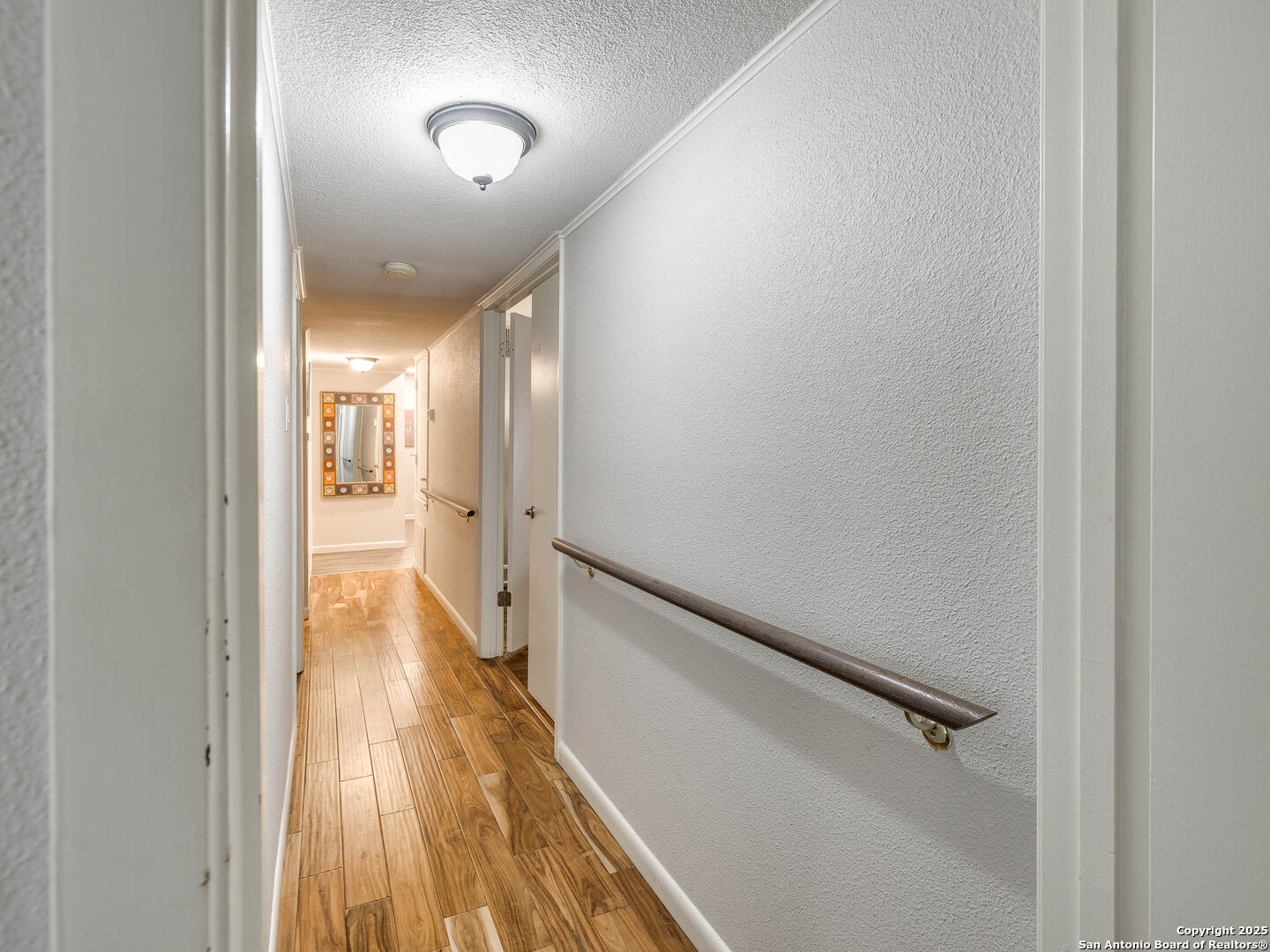 7711 Callaghan Road, Unit 702 San Antonio, TX 78229 - Photo 14 of 49 a view of a hallway with wooden floor