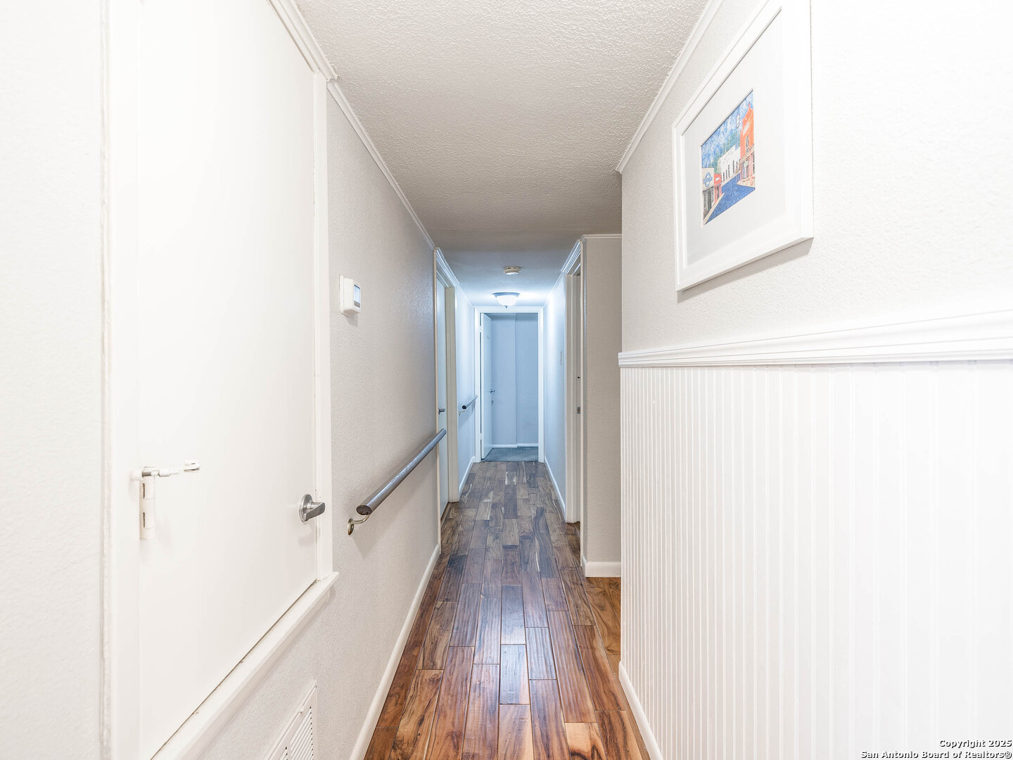 7711 Callaghan Road, Unit 702 San Antonio, TX 78229 - Photo 16 of 49 a view of a hallway with wooden floor and staircase