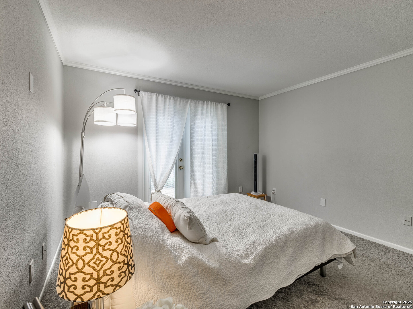 7711 Callaghan Road, Unit 702 San Antonio, TX 78229 - Photo 18 of 49 a bedroom with a bed and a lamp