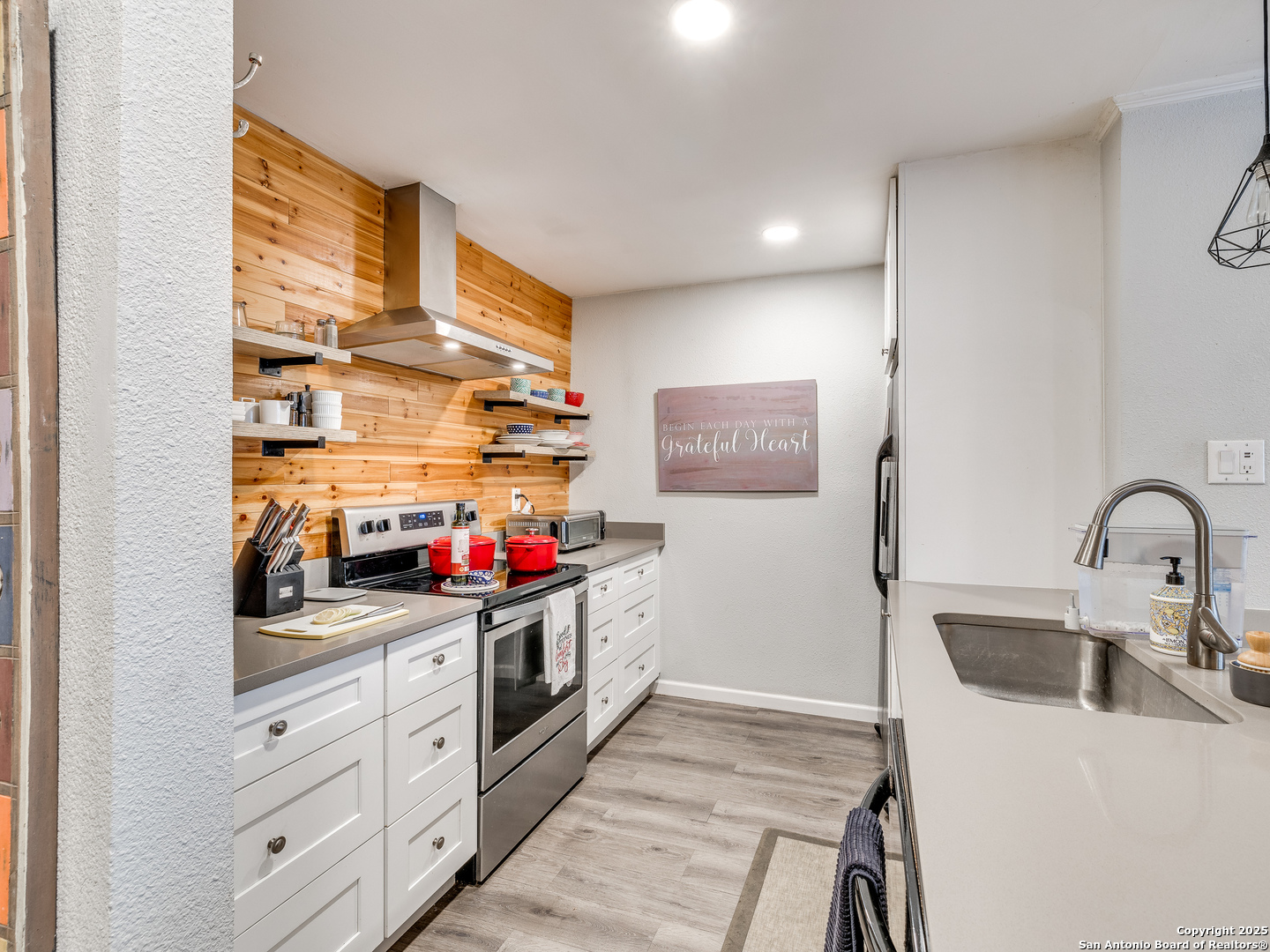 7711 Callaghan Road, Unit 702 San Antonio, TX 78229 - Photo 26 of 49 a kitchen with stainless steel appliances a sink dishwasher and cabinets with wooden floor