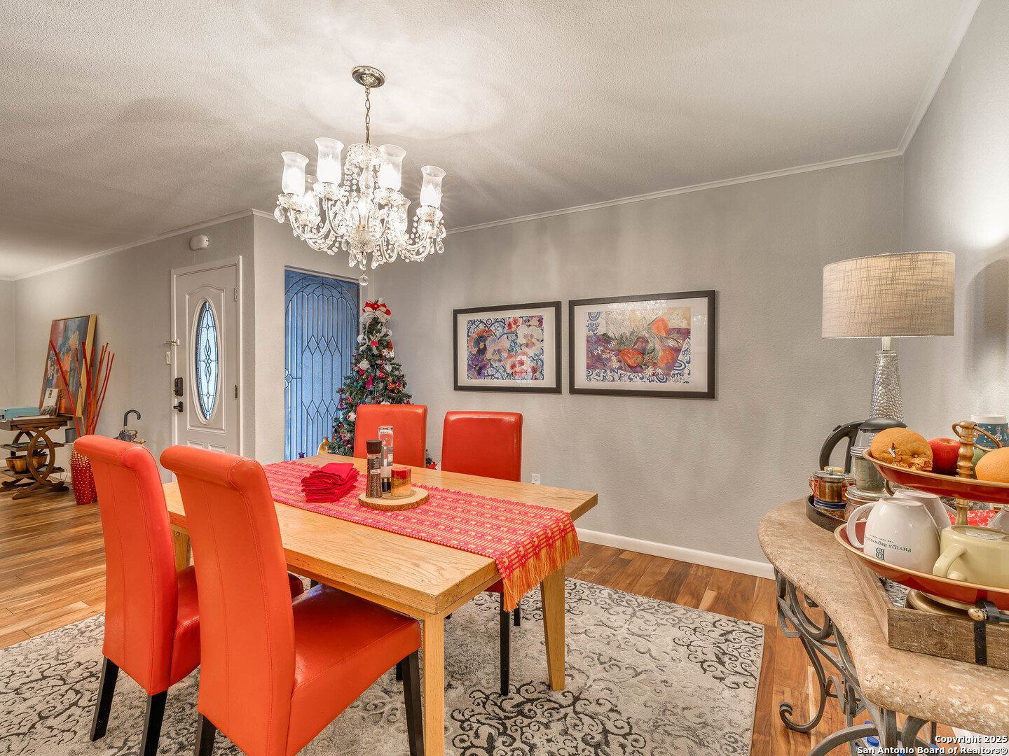 7711 Callaghan Road, Unit 702 San Antonio, TX 78229 - Photo 29 of 49 a dining room with furniture and chandelier