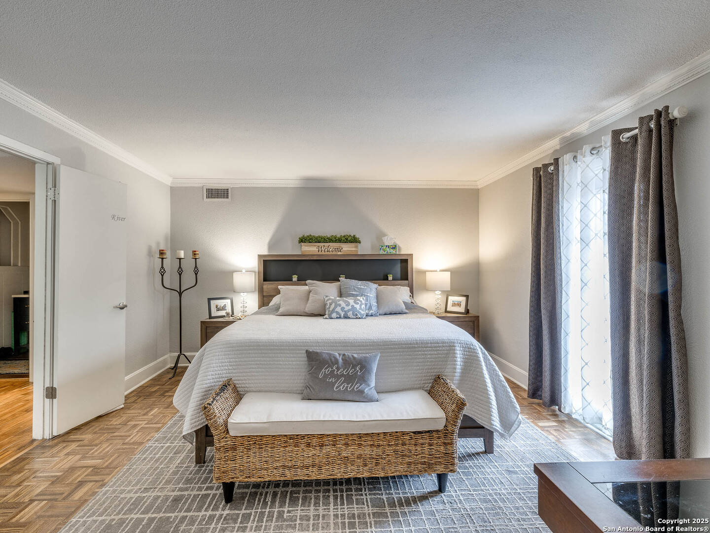 7711 Callaghan Road, Unit 702 San Antonio, TX 78229 - Photo 3 of 49 a bedroom with a bed and wooden floor