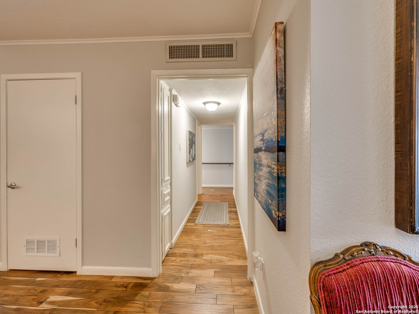 7711 Callaghan Road, Unit 702 San Antonio, TX 78229 - Photo 33 of 49 a view of a hallway with wooden floor and a bathroom