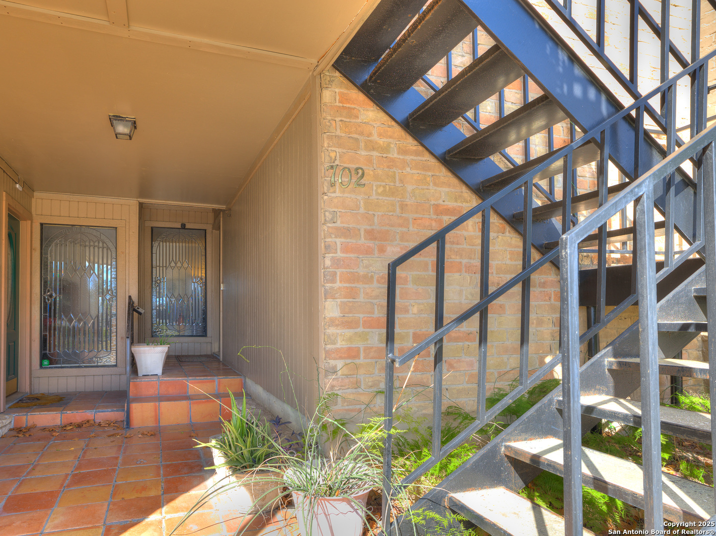 7711 Callaghan Road, Unit 702 San Antonio, TX 78229 - Photo 37 of 49 a porch with a potted plant in front of it