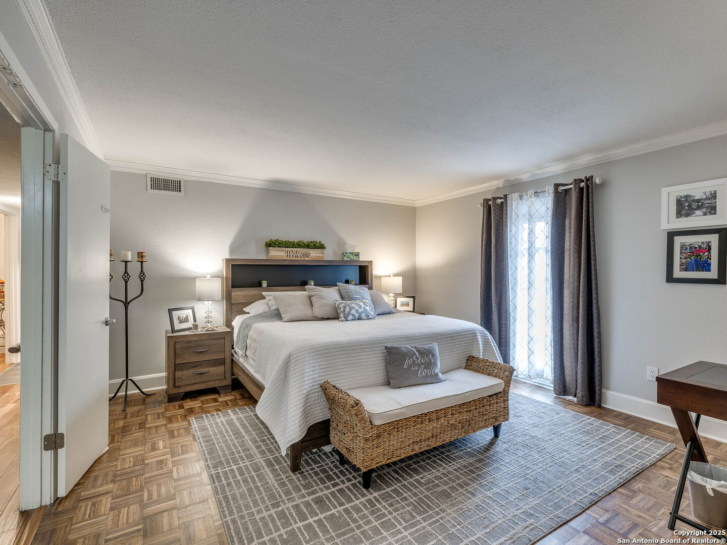 7711 Callaghan Road, Unit 702 San Antonio, TX 78229 - Photo 4 of 49 a spacious bedroom with a bed and wooden floor