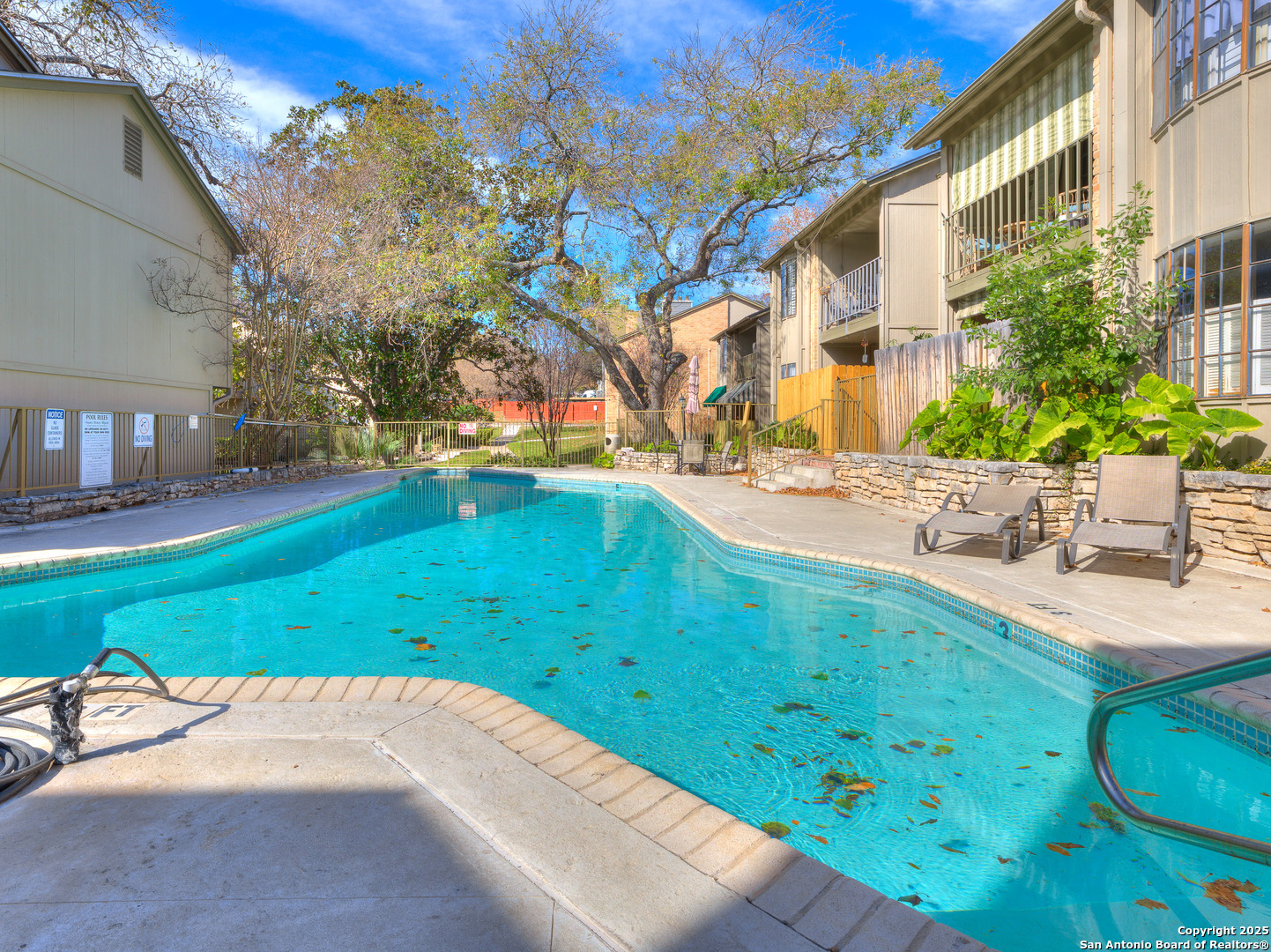 7711 Callaghan Road, Unit 702 San Antonio, TX 78229 - Photo 42 of 49 a backyard of a house with table and chairs