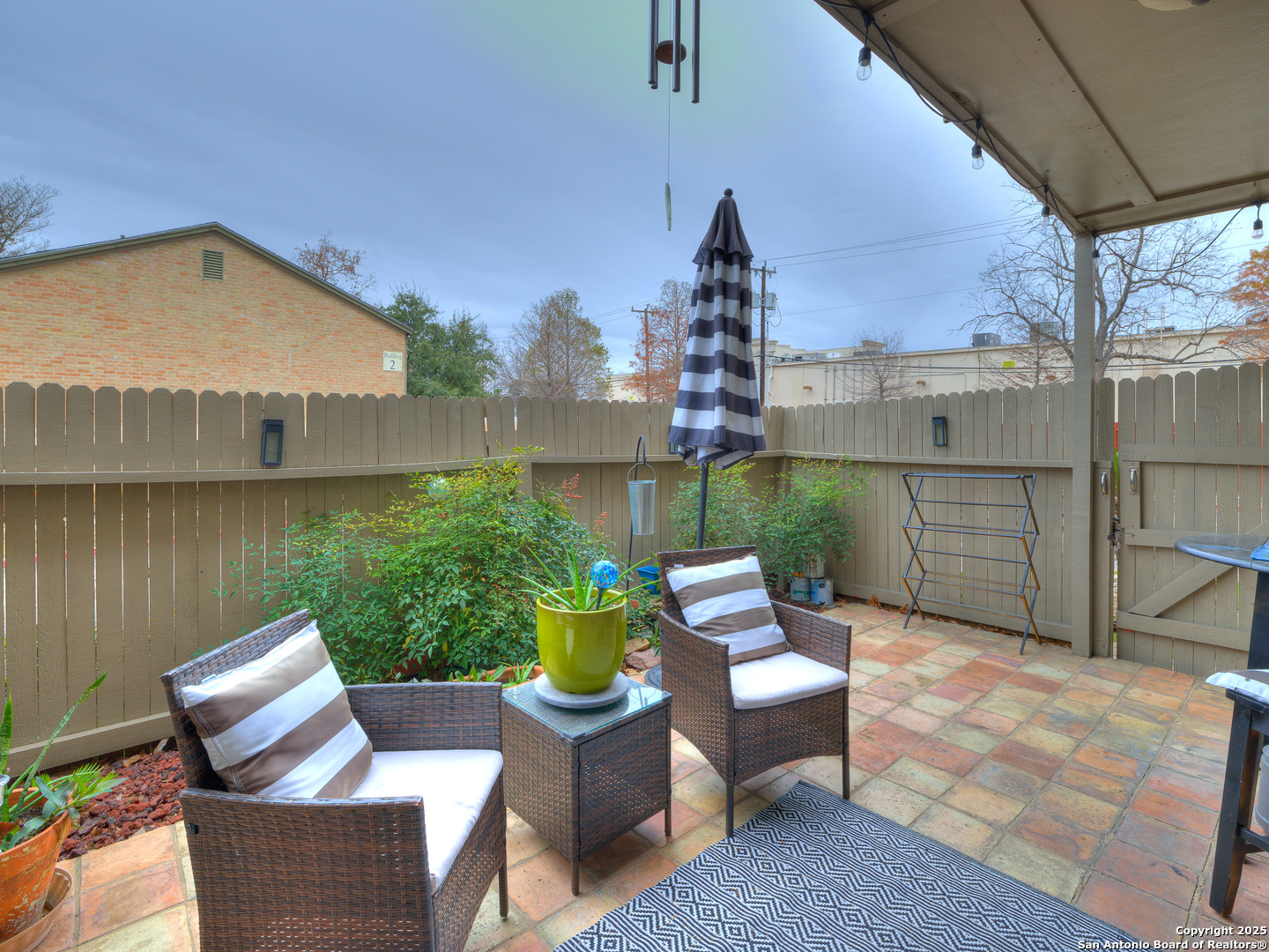 7711 Callaghan Road, Unit 702 San Antonio, TX 78229 - Photo 48 of 49 a view of a patio with couches chairs potted plants and a table