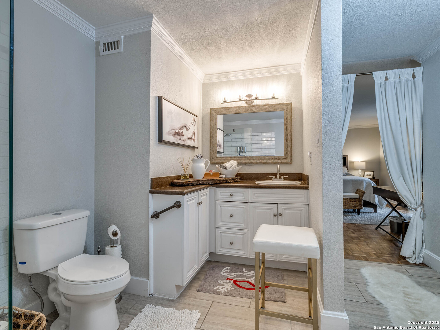 7711 Callaghan Road, Unit 702 San Antonio, TX 78229 - Photo 8 of 49 a spacious bathroom with a toilet sink and mirror