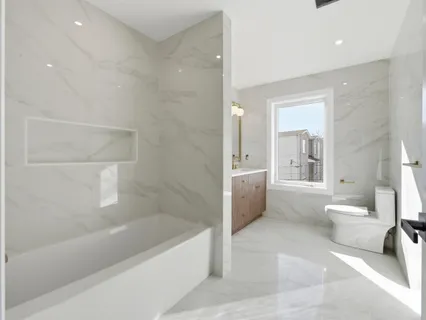 a bathroom with a bathtub and toilet