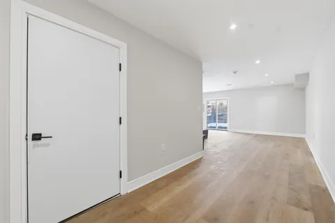 an empty room with closet and a window