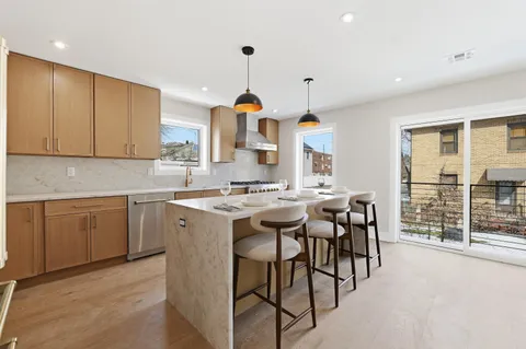 a kitchen with a sink cabinets and window