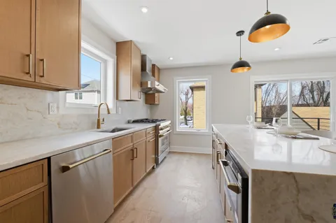 a kitchen with a sink stove and cabinets