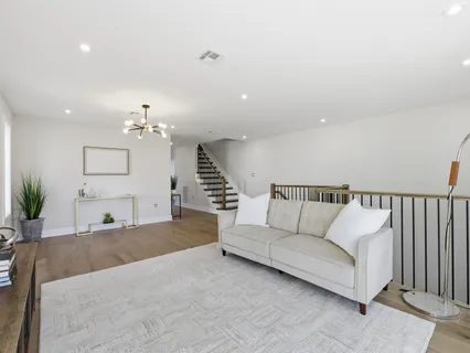 a living room with furniture and a chandelier