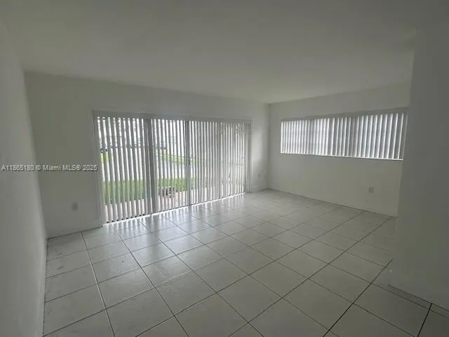 a view of an empty room and a window