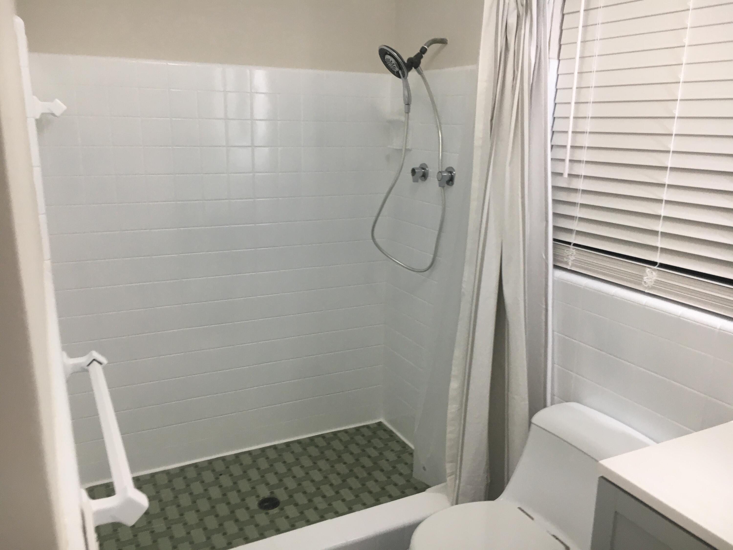 1140 Hernando Street Fort Pierce, FL 34949 - Photo 12 of 37 a bathroom with a shower toilet and sink