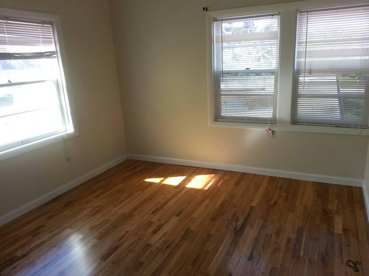 1140 Hernando Street Fort Pierce, FL 34949 - Photo 23 of 37 a view of an empty room with wooden floor and a window