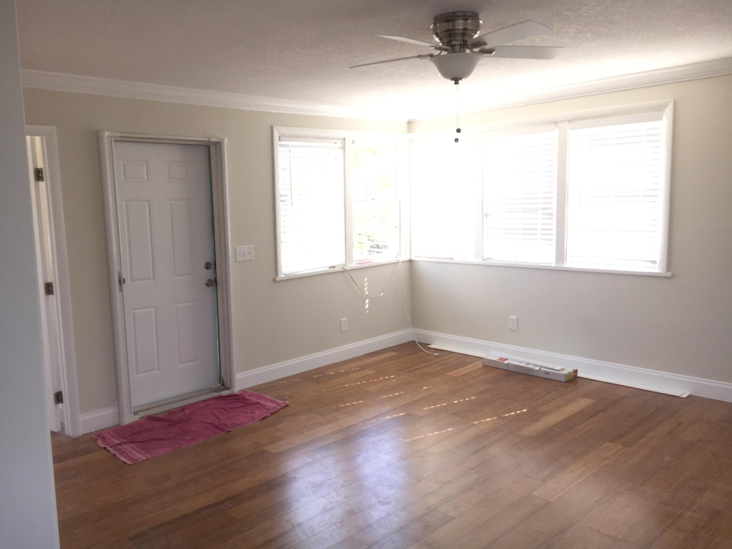 1140 Hernando Street Fort Pierce, FL 34949 - Photo 29 of 37 an empty room with wooden floor and windows