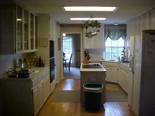 a kitchen with sink cabinets and window