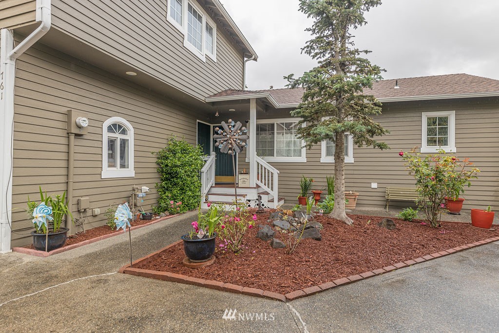 761 Vashon Place Northeast Renton, WA 98059 - Photo 1 of 1 a front view of a house with garden