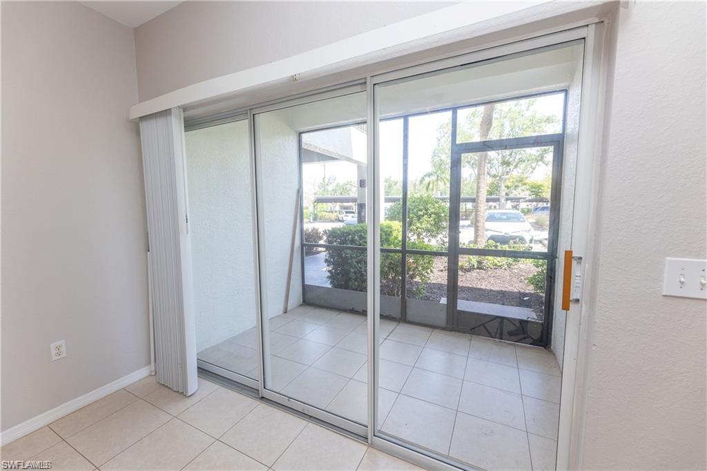 7975 Preserve Circle, Unit 1013 Naples, FL 34119 - Photo 10 of 16 a room with sliding glass door