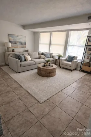 a living room with furniture and a large window