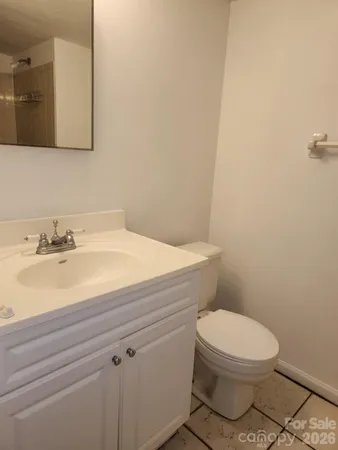 a bathroom with a sink a toilet and mirror