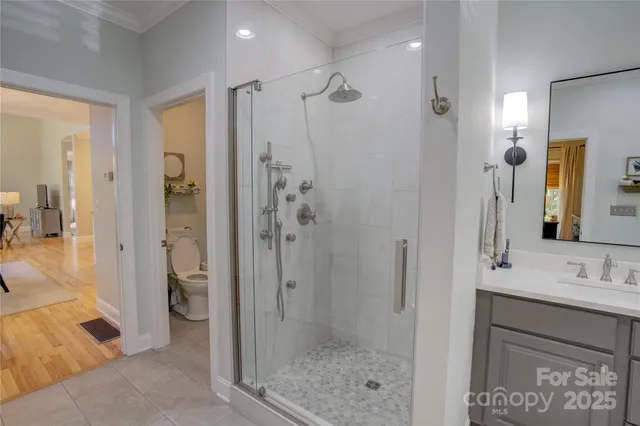 a bathroom with a shower sink and mirror