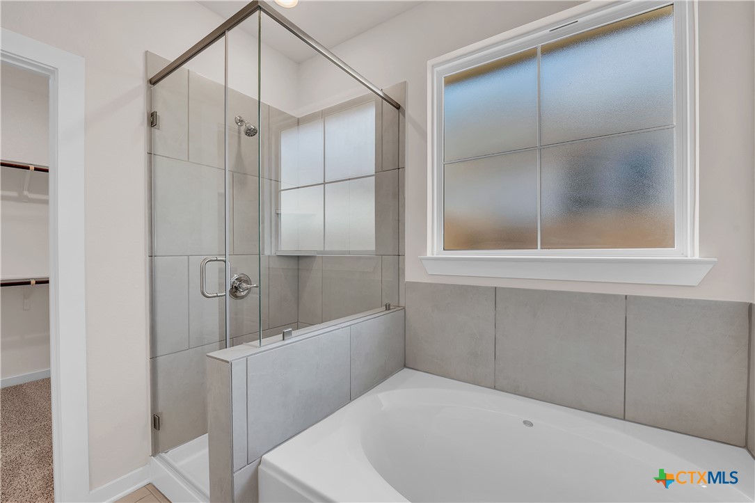 262 Wind Ridge Drive Copperas Cove, TX 76522 - Photo 12 of 30 a bathroom with a bathtub and a shower