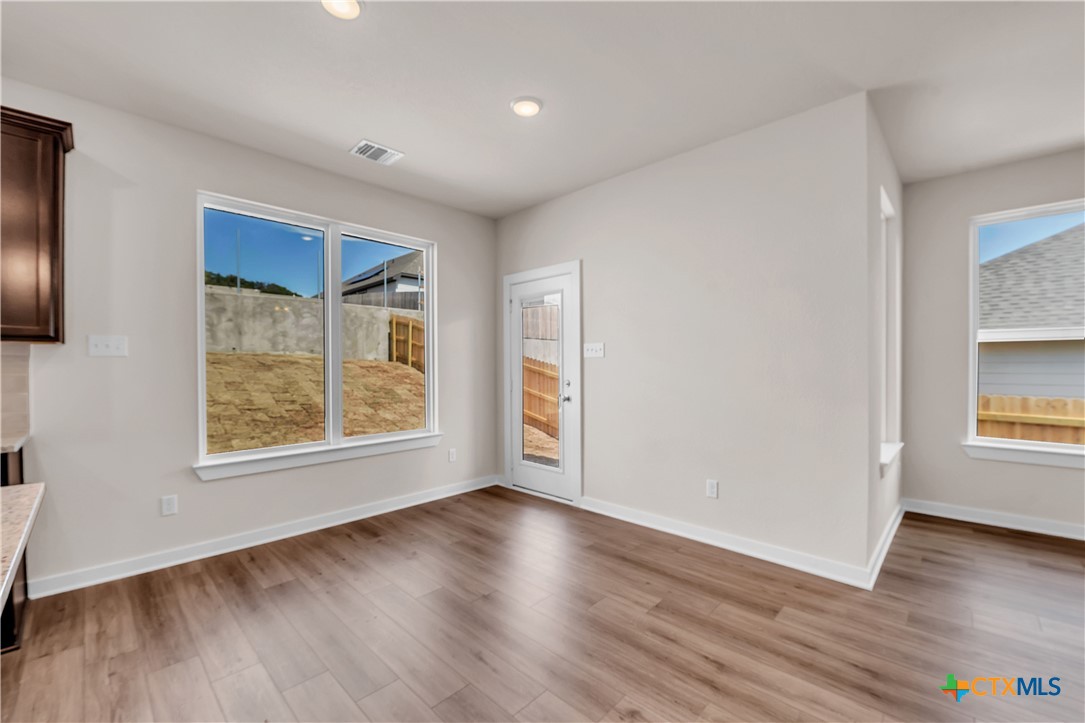 262 Wind Ridge Drive Copperas Cove, TX 76522 - Photo 18 of 30 an empty room with wooden floor and windows