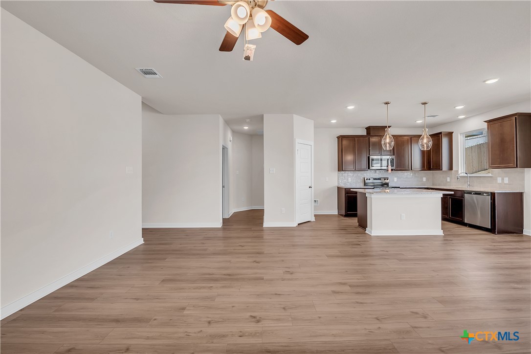 262 Wind Ridge Drive Copperas Cove, TX 76522 - Photo 26 of 30 a view of kitchen with kitchen island stainless steel appliances sink cabinets and wooden floor