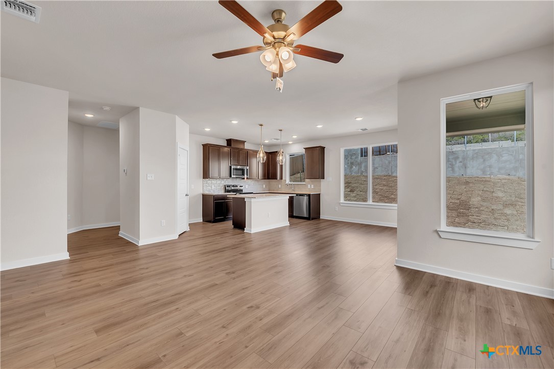 262 Wind Ridge Drive Copperas Cove, TX 76522 - Photo 27 of 30 a view of a kitchen with a stove cabinets and wooden floor