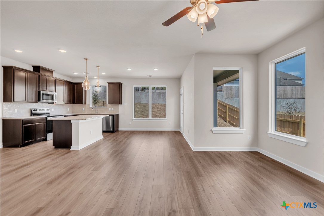 262 Wind Ridge Drive Copperas Cove, TX 76522 - Photo 28 of 30 a large kitchen with stainless steel appliances granite countertop a stove a sink dishwasher and a oven with wooden floors