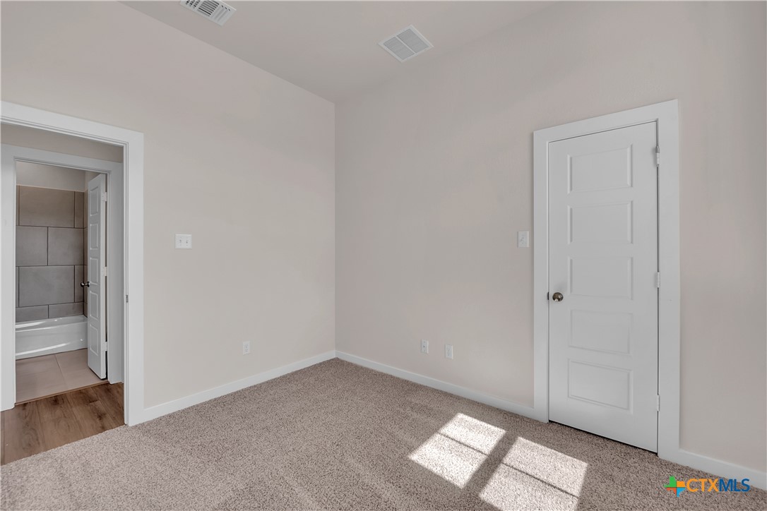 262 Wind Ridge Drive Copperas Cove, TX 76522 - Photo 4 of 30 an empty room with wooden floor and windows