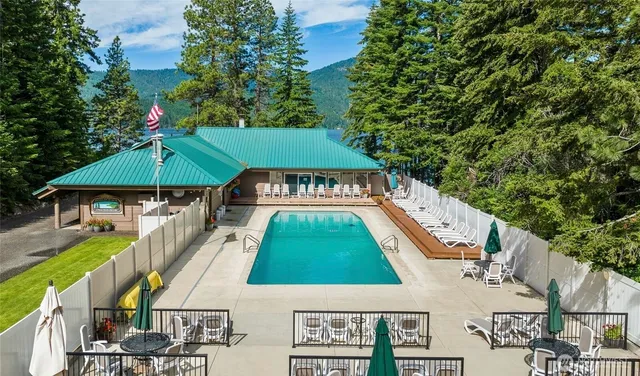 a backyard of a house with barbeque oven and outdoor seating