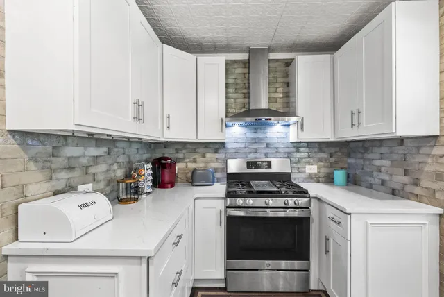 a kitchen with a table and chairs in it