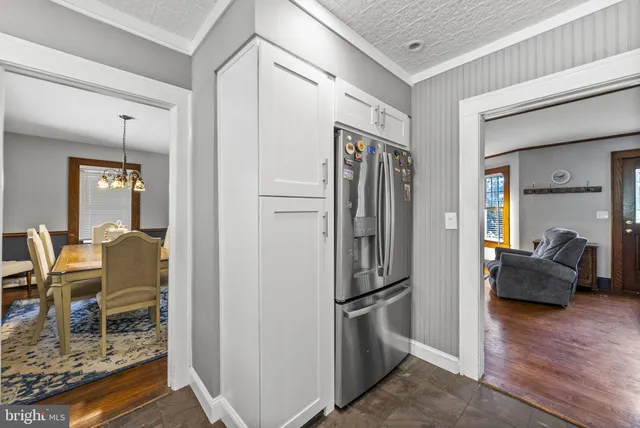 a view of a dining room and livingroom with furniture wooden floor and a window