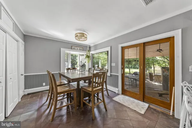 an aerial view of residential houses with outdoor space and trees