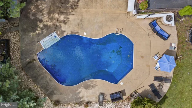 an aerial view of house with yard swimming pool and outdoor seating