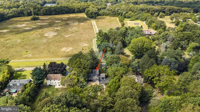 an aerial view of a house with swimming pool and outdoor space