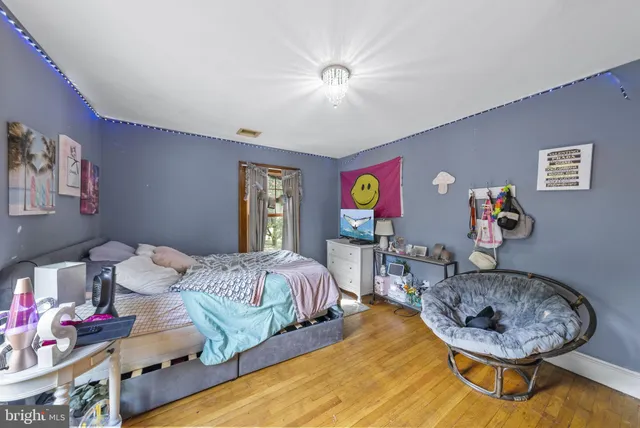 a living room with furniture a flat screen tv and large windows