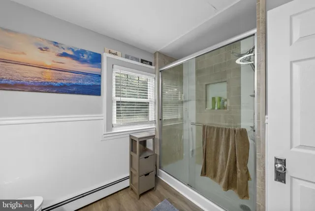 a view of pool with table and chairs under an umbrella