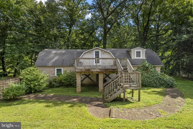 a view of a house with swimming pool and porch with furniture