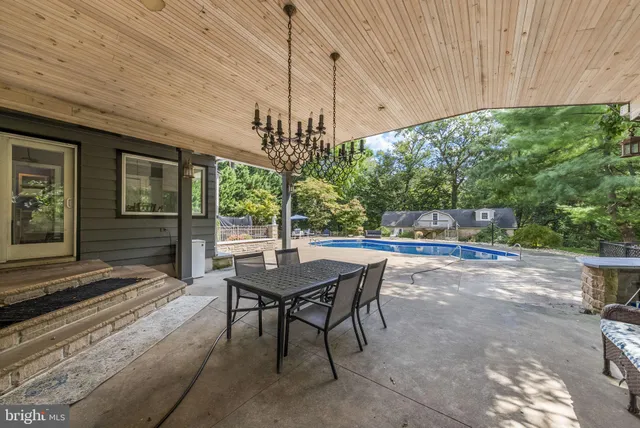 a bed room with a bed and a lamp on dresser