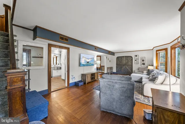 a living room with furniture a rug and a large window